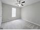 Cozy bedroom with plush carpet, neutral walls, and ceiling fan at 537 Goldfinch Way, Stockbridge, GA 30281