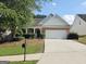 Charming one-story home with brick facade, manicured lawn, and attached two-car garage at 537 Goldfinch Way, Stockbridge, GA 30281