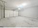 View of an empty two car garage with a cement floor and a door in the back at 537 Goldfinch Way, Stockbridge, GA 30281