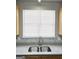 Close-up of kitchen sink with granite countertops and tile backsplash at 537 Goldfinch Way, Stockbridge, GA 30281