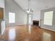 Open-concept living room with hardwood floors, fireplace, ceiling fan, and backyard access at 537 Goldfinch Way, Stockbridge, GA 30281