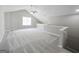 Loft area featuring carpet, vaulted ceilings, a ceiling fan, and natural light from a window at 537 Goldfinch Way, Stockbridge, GA 30281