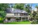 Back exterior view with a spacious deck overlooking the yard and a walk out basement at 110 Tamerlane, Peachtree City, GA 30269