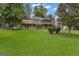 A lush backyard featuring a screened-in porch and mature trees, offering a private outdoor space at 110 Tamerlane, Peachtree City, GA 30269