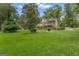 A well-maintained backyard with a deck and a screened-in porch, surrounded by mature trees at 110 Tamerlane, Peachtree City, GA 30269