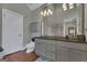 Bright bathroom featuring a commode, double sink vanity, and wood floors at 110 Tamerlane, Peachtree City, GA 30269