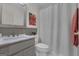 Bright bathroom featuring a marble vanity, commode and shower with curtain at 110 Tamerlane, Peachtree City, GA 30269