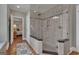 Glass enclosed shower featuring stone surround, black trim and a mosaic accent stripe at 110 Tamerlane, Peachtree City, GA 30269