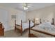Charming bedroom with two beds, ceiling fan, and neutral decor at 110 Tamerlane, Peachtree City, GA 30269