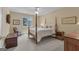 Comfortable bedroom with neutral decor, four poster bed, and natural light at 110 Tamerlane, Peachtree City, GA 30269