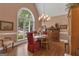 Elegant dining room featuring a large window, chandelier, and hardwood floors at 110 Tamerlane, Peachtree City, GA 30269