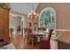 Elegant dining room featuring a large window, chandelier, and hardwood floors at 110 Tamerlane, Peachtree City, GA 30269