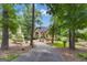 Lovely single Gathering home featuring mature trees, well manicured landscaping, and a circular driveway at 110 Tamerlane, Peachtree City, GA 30269