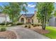 Charming stucco home featuring a red front door, mature trees, and a well-manicured lawn at 110 Tamerlane, Peachtree City, GA 30269
