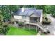 Back exterior elevation featuring multi-level decks, screened-in porch, and manicured lawn at 110 Tamerlane, Peachtree City, GA 30269