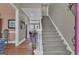 Inviting foyer featuring hardwood floors and a staircase leading to the upper level at 110 Tamerlane, Peachtree City, GA 30269