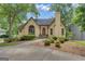 Charming stucco home featuring a red front door, mature trees, and a well-manicured lawn at 110 Tamerlane, Peachtree City, GA 30269