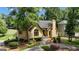 View of home highlighting the landscaping, mature trees, and architectural details at 110 Tamerlane, Peachtree City, GA 30269
