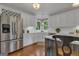 Bright kitchen featuring white cabinetry, stainless steel appliances, and a wine rack at 110 Tamerlane, Peachtree City, GA 30269