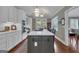 Open kitchen featuring an island with cooktop, stainless appliances, and white countertops at 110 Tamerlane, Peachtree City, GA 30269