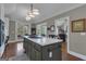 Spacious kitchen boasts a center island with cooktop, white cabinets, and access to the screened porch at 110 Tamerlane, Peachtree City, GA 30269