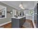 Kitchen view showing center island with cooktop, hardwood flooring, and access to living area at 110 Tamerlane, Peachtree City, GA 30269