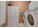 Functional laundry room with washer, dryer, and storage cabinets at 110 Tamerlane, Peachtree City, GA 30269