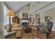 Comfortable living room featuring a fireplace, hardwood floors, and vaulted ceiling at 110 Tamerlane, Peachtree City, GA 30269