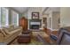 Inviting living room with fireplace, hardwood floors, and plenty of seating at 110 Tamerlane, Peachtree City, GA 30269