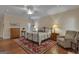 Comfortable main bedroom boasting a ceiling fan, hardwood floors and soft lighting at 110 Tamerlane, Peachtree City, GA 30269