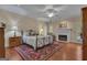 Cozy main bedroom featuring a fireplace, ceiling fan, and hardwood floors at 110 Tamerlane, Peachtree City, GA 30269