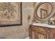 Elegant powder room featuring a decorative vanity and detailed mirror at 110 Tamerlane, Peachtree City, GA 30269