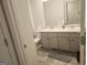 Bathroom featuring dual sinks, a large mirror, gray vanity, and tile flooring at 160 Grafton St, Hampton, GA 30228