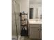 Bathroom with a shower and a shelf with bath products at 160 Grafton St, Hampton, GA 30228