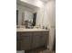 Bathroom featuring dual sinks, a large mirror, and a white vanity at 160 Grafton St, Hampton, GA 30228