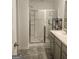 Bathroom featuring a glass shower door and tile flooring at 160 Grafton St, Hampton, GA 30228