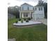 Charming two-story home featuring a welcoming front porch, manicured lawn, and a two-car garage at 160 Grafton St, Hampton, GA 30228