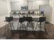 Open-concept kitchen with bar seating, stainless steel appliances, and stylish gray cabinetry at 160 Grafton St, Hampton, GA 30228