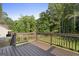 A charming backyard deck overlooks a lush green space, providing a serene outdoor retreat at 128 Southern Magnolia Ln, Rex, GA 30273