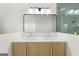 Bright bathroom featuring a double vanity, modern mirror, and designer lighting at 128 Southern Magnolia Ln, Rex, GA 30273