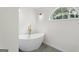 Elegant bathroom featuring a freestanding tub with gold fixtures and a large window at 128 Southern Magnolia Ln, Rex, GA 30273
