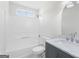 Well-lit bathroom with a shower-tub combination, vanity, and coordinated finishes at 128 Southern Magnolia Ln, Rex, GA 30273