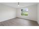 Bright bedroom with hardwood floors, neutral paint, and a large window offering natural light at 128 Southern Magnolia Ln, Rex, GA 30273