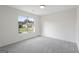 Bright bedroom with plush gray carpet and a large window offering neighborhood views at 128 Southern Magnolia Ln, Rex, GA 30273