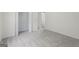 Carpeted bedroom with a closet and access to the rest of the home through an open doorway at 128 Southern Magnolia Ln, Rex, GA 30273