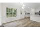 Bright dining area featuring large windows, hardwood floors, and modern light fixture at 128 Southern Magnolia Ln, Rex, GA 30273