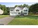 Traditional two-story home with a lush green lawn and a double garage, offering great curb appeal at 128 Southern Magnolia Ln, Rex, GA 30273