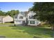 Charming two-story home featuring a two-car garage, manicured lawn, and inviting front entrance at 128 Southern Magnolia Ln, Rex, GA 30273