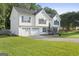 Charming two-story home with a well-manicured front yard and a two-car garage at 128 Southern Magnolia Ln, Rex, GA 30273