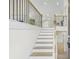 Inviting foyer features hardwood stairs and a modern metal railing with a view to the kitchen at 128 Southern Magnolia Ln, Rex, GA 30273